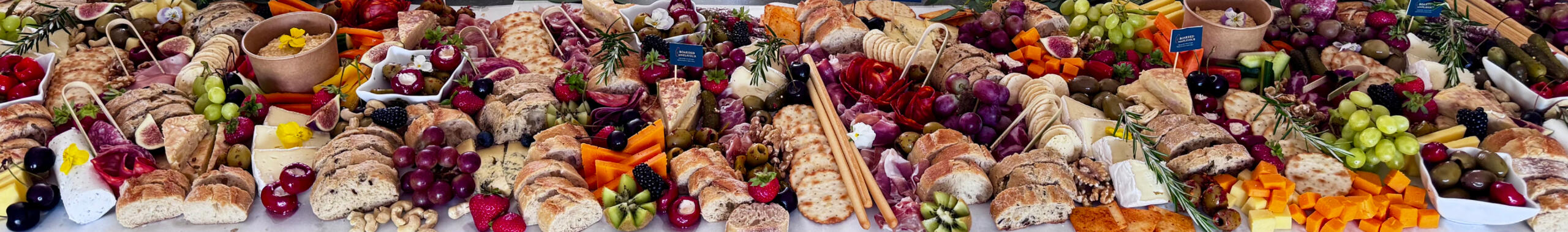 The Indulge Event Table £15.95 per person (min 12 people) An Indulge Event table with artisan cheeses, cured meats, and fruit